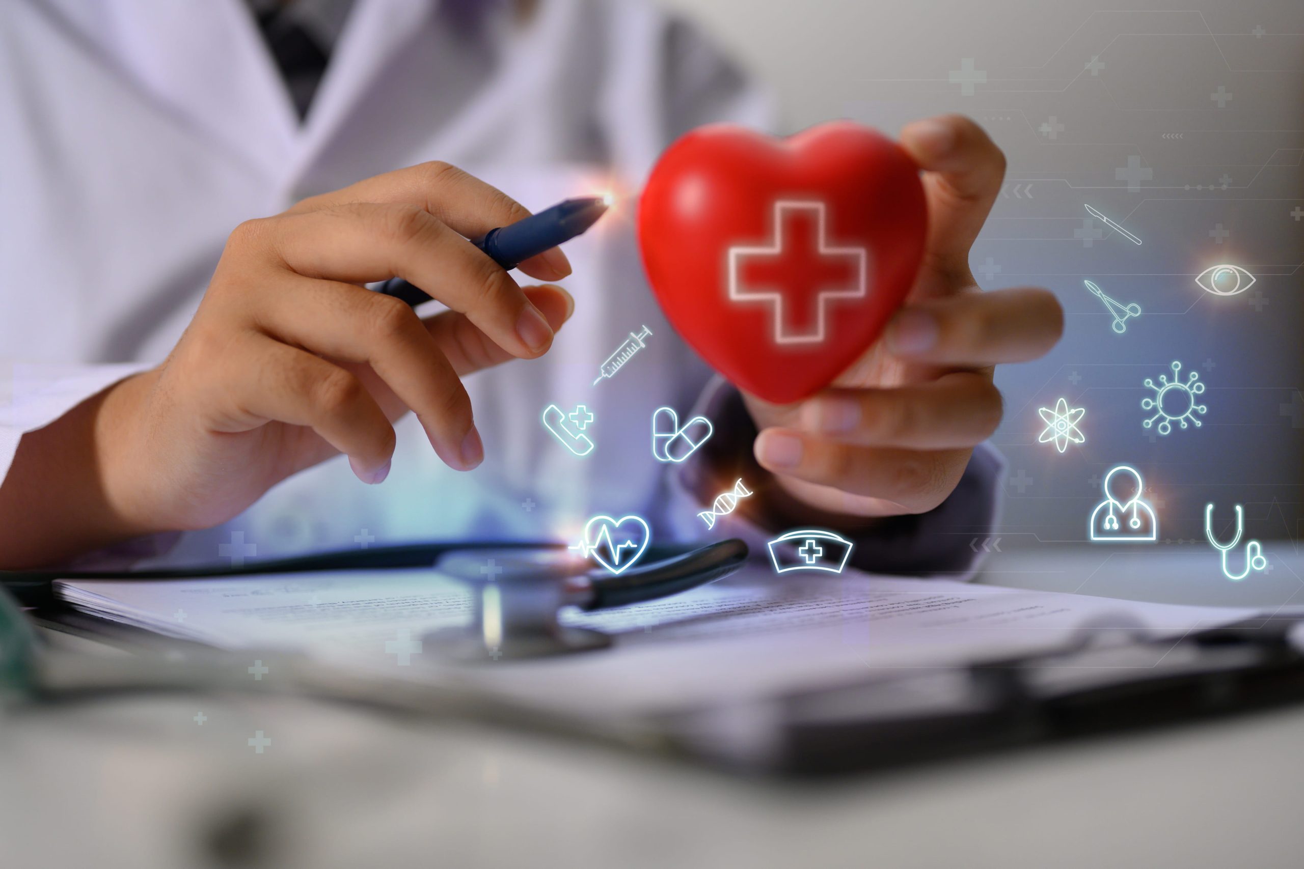 closeup-cardiologist-holding-red-heart-shape-with-virtual-medical-icons-health-care-concept